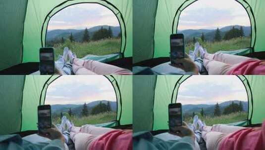 两人在帐篷里玩手机高清在线视频素材下载