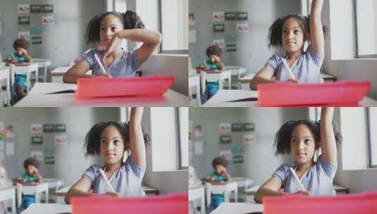 快乐的混血儿女孩在教室上课时举手的视频高清在线视频素材下载
