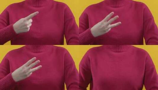 读数女性手计数从1到3，手指在黄色红色背景高清在线视频素材下载