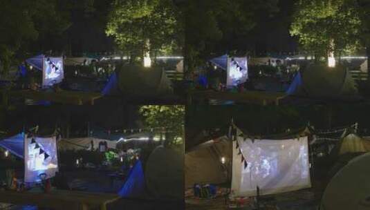 夜晚在帐篷里看露天电影高清在线视频素材下载