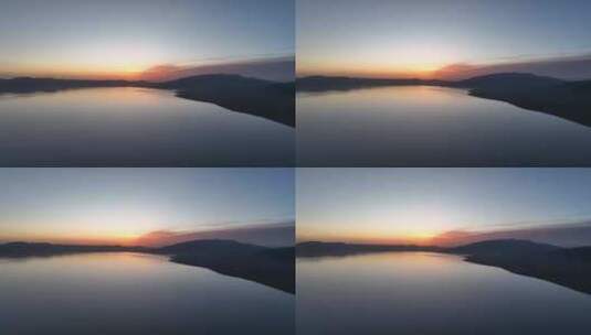 清晨朝霞倒映在赛里木湖平静的湖面航拍高清在线视频素材下载