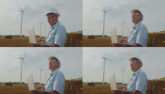 风力发电场手持笔记本电脑的风力涡轮机工程高清在线视频素材下载