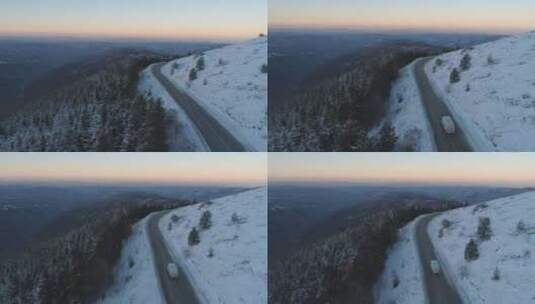 航拍冬日里山路行驶的汽车自然风光风景高清在线视频素材下载
