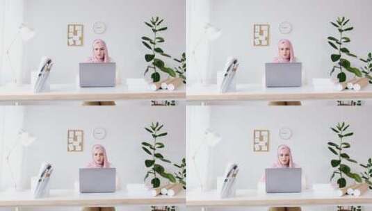穆斯林女士坐在电脑前工作高清在线视频素材下载