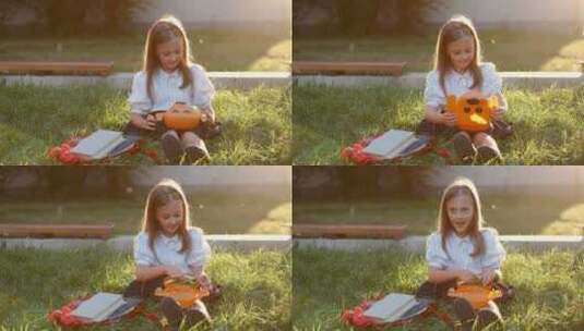 小女孩坐在草坪上吃早餐高清在线视频素材下载