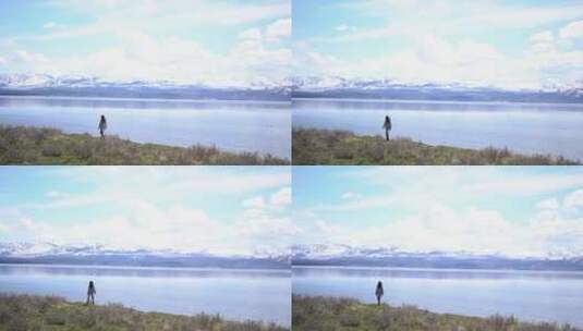 一个女人在湖边散步欣赏风景高清在线视频素材下载