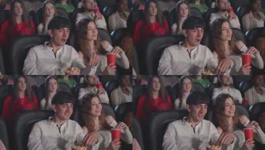 年轻夫妇在电影院看电影吃爆米花高清在线视频素材下载