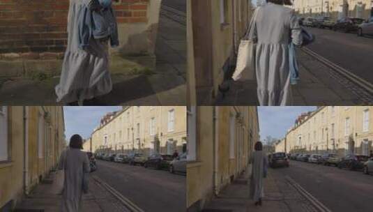 女子在安静的街角行走的追踪镜头高清在线视频素材下载