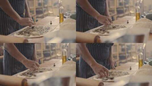 面包师将橄榄油抹在面饼上高清在线视频素材下载