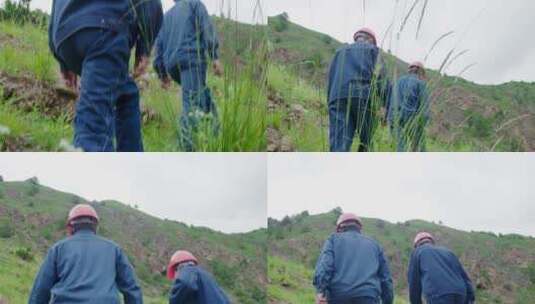两名工人行走在长满杂草的山坡上高清在线视频素材下载