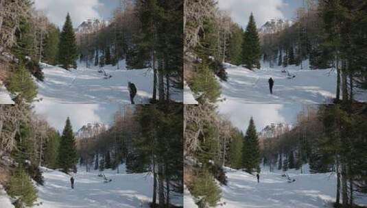 走在覆盖着厚厚的积雪的步道上。一个男人在斯洛文尼亚的卡拉万克阿尔卑斯山徒步旅行。高清在线视频素材下载