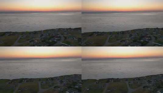 夕阳下惠德贝岛海滨社区的鸟瞰图。高清在线视频素材下载