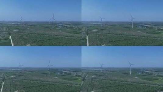 村镇城市绿色庄稼地树林风力发电大风车高清在线视频素材下载