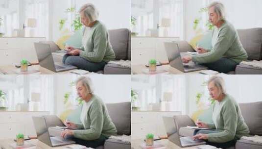 笔记本电脑、写作和财务文件与一位老妇人在高清在线视频素材下载