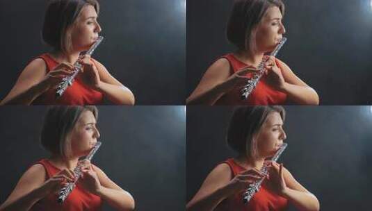 职业音乐家女性长笛演奏。烟雾工作室高清在线视频素材下载