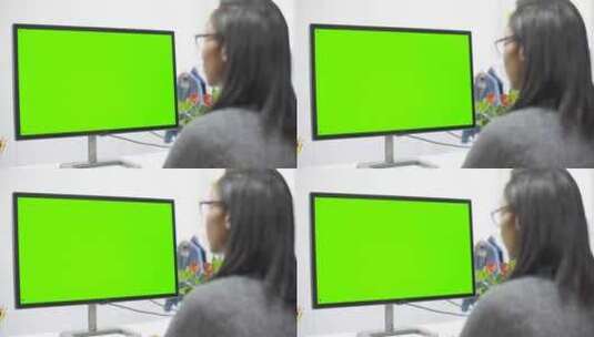 在电脑色度屏幕上工作的女人高清在线视频素材下载