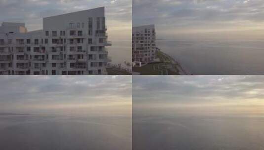 航拍早晨的大海边上的居民楼高清在线视频素材下载