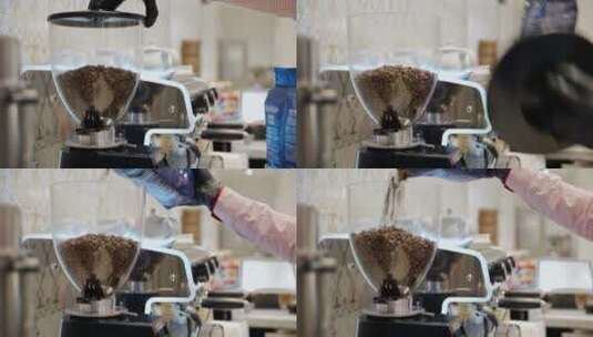 咖啡师将咖啡豆倒入研磨机高清在线视频素材下载