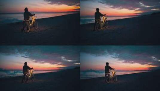 夕阳下海滩上推着自行车高清在线视频素材下载
