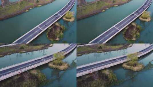 高空视角俯拍水上公路行驶的摩托车高清在线视频素材下载