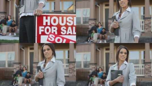 女子站在待售房屋的牌子旁打广告高清在线视频素材下载