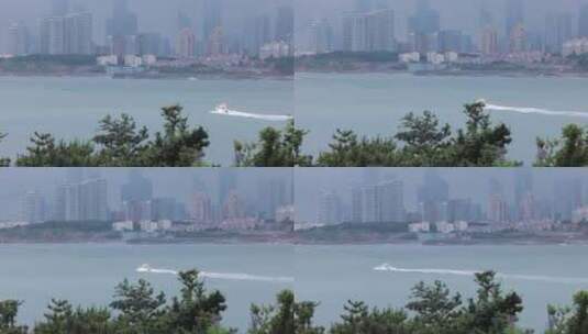 游艇从城市附近的海面驶过高清在线视频素材下载