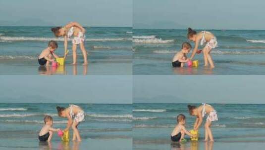 快乐无忧无虑的孩子们在海边玩沙子。孩子们玩耍，兄弟姐妹玩耍高清在线视频素材下载
