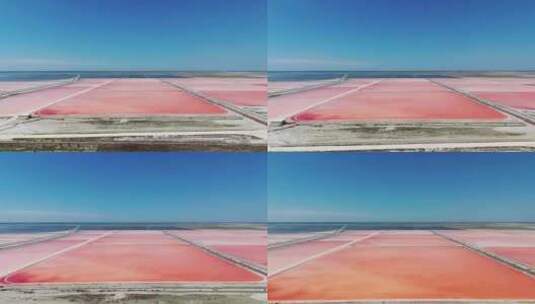 在粉色沉积物的阿尔巴尼亚海盐农场上空飞行高清在线视频素材下载