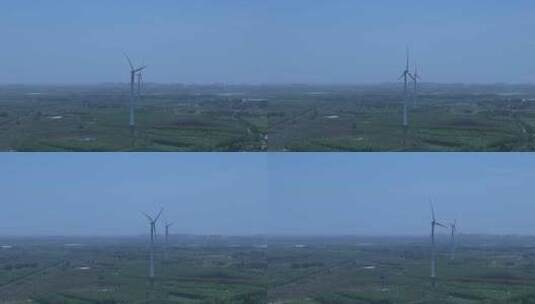 村镇城市绿色庄稼地树林风力发电大风车横移高清在线视频素材下载