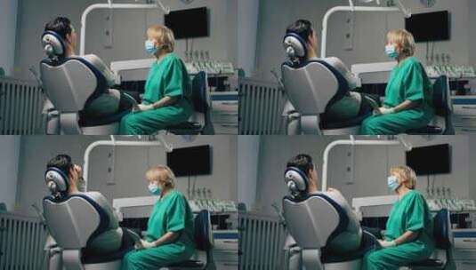 一名牙科诊所病人与一名拿着镜子咨询的女牙高清在线视频素材下载