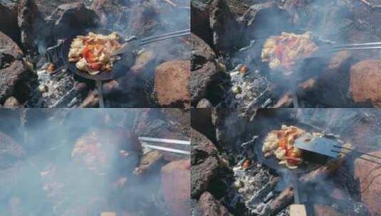用铸铁平底锅和抹刀在篝火上烹饪食物。PO高清在线视频素材下载