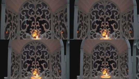黑色背景前烛台灯里被点燃的蜡烛高清在线视频素材下载