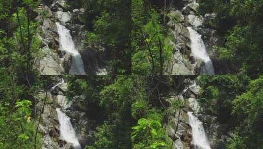无人机在绿色灌木中上升，萨尔托斯·吉马瀑布从小岩石悬崖上流出高清在线视频素材下载