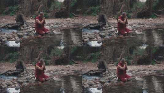 僧侣坐在河流边祈祷高清在线视频素材下载
