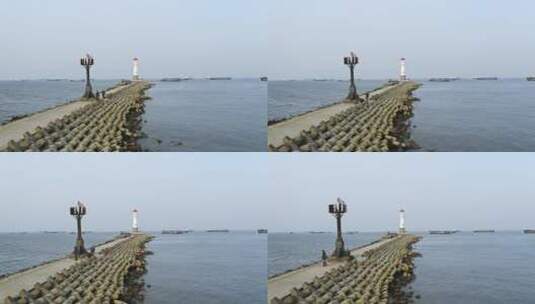 航拍海岸堤坝小路与灯塔高清在线视频素材下载