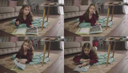 小女孩合上书本趴在地毯上休息高清在线视频素材下载