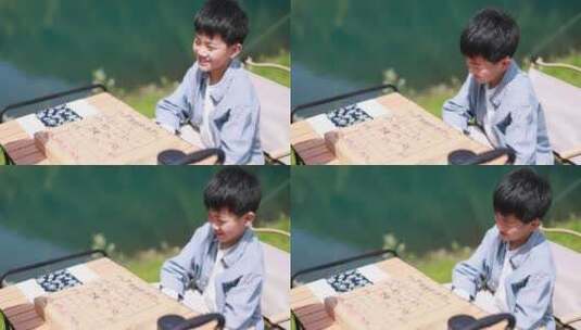 在湖边下棋的中国男孩 升格慢镜高清在线视频素材下载