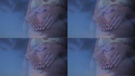 孕妇用手捂住肚子做心脏高清在线视频素材下载