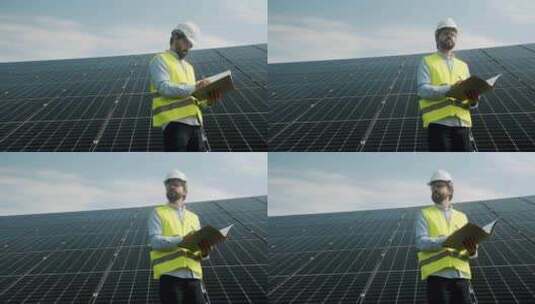 一名工人在户外检查光伏电站的太阳能电池板高清在线视频素材下载