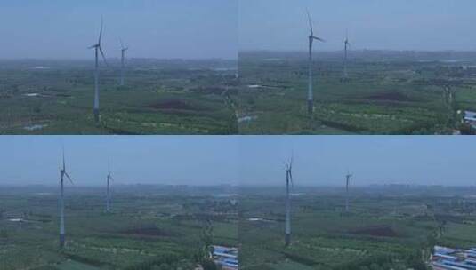 村镇城市绿色庄稼地树林风力发电大风车环绕高清在线视频素材下载