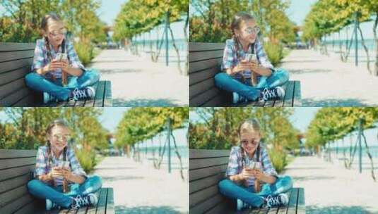 公园长椅上玩手机的女孩高清在线视频素材下载