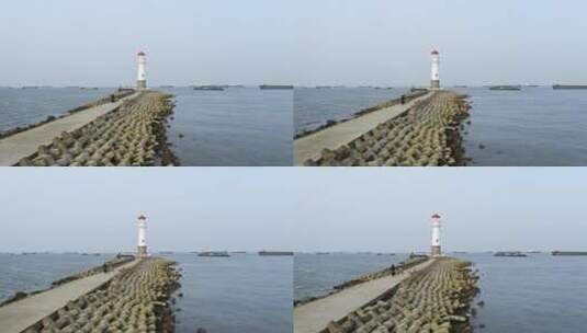 航拍海岸堤坝小路与灯塔高清在线视频素材下载