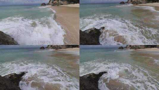 海滩沙滩海水冲岩石海浪浪花飞溅手持镜头高清在线视频素材下载
