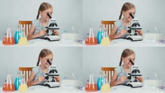 女孩在使用显微镜做实验高清在线视频素材下载