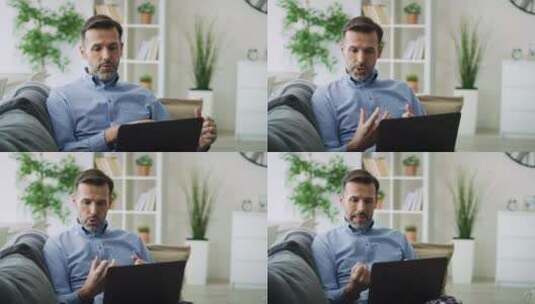 男人坐在沙发上进行视频会议高清在线视频素材下载