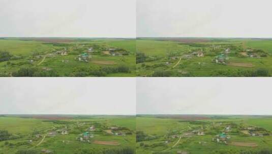 绿色开阔的田野和一个村庄高清在线视频素材下载