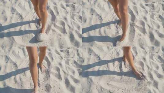 女人在沙滩上用脚玩沙子高清在线视频素材下载