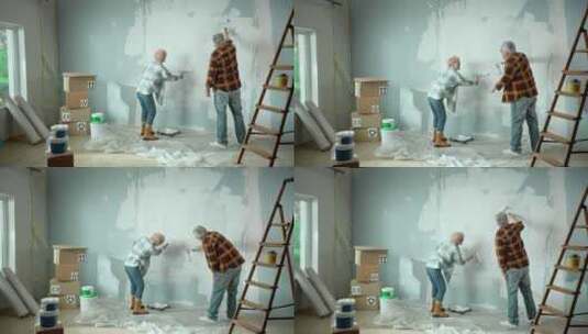老人和女人用滚筒油漆粉刷墙壁高清在线视频素材下载
