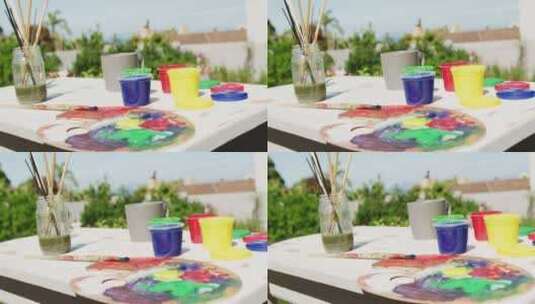 花园里桌子上彩色油漆和绘画设备的特写高清在线视频素材下载