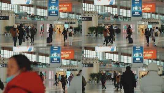 南京火车站里匆匆忙忙拿着行李走过的乘客高清在线视频素材下载